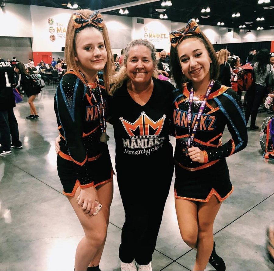 Freshman Paige Martinez with teammate and coach at Maniakz cheer competition