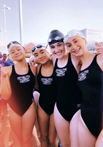 Jimenez poses for pictures with swimmers at a meet