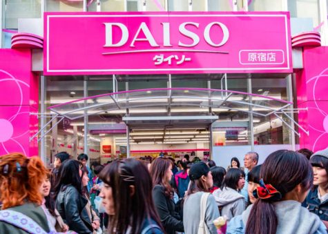 The bright pink logo of Daiso attracts customers worldwide