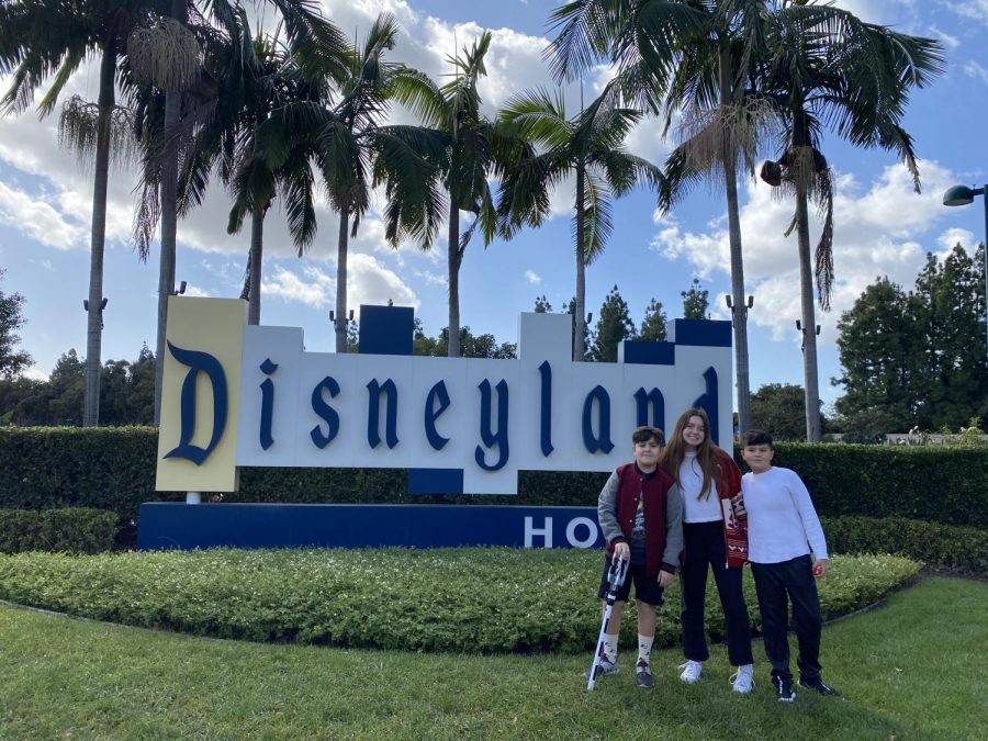 Garcia poses at the Disneyland sign with her brothers