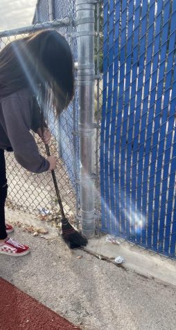 Nakai Kuewa sweeping under the gates from the wind storms that blew trash everywhere.