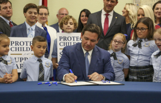 Florida Governor Ron DeSantis signing the bill