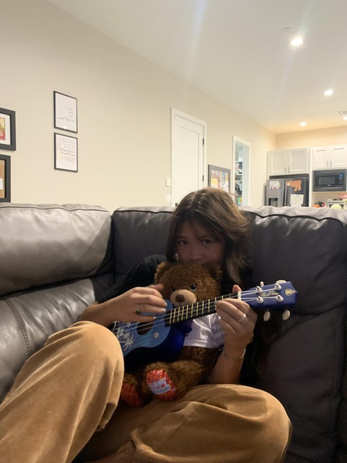 Soriya Ritchie relaxing and playing the ukulele