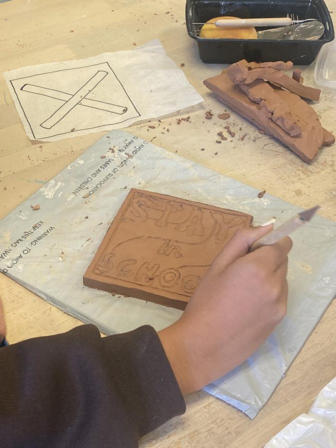 Ceramics one putting the final touches on their project.