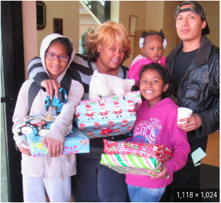 A family with their gifts during a previous years toy drive