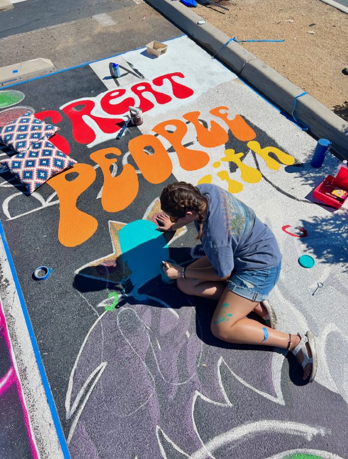 Ava Garcia painting her parking spot