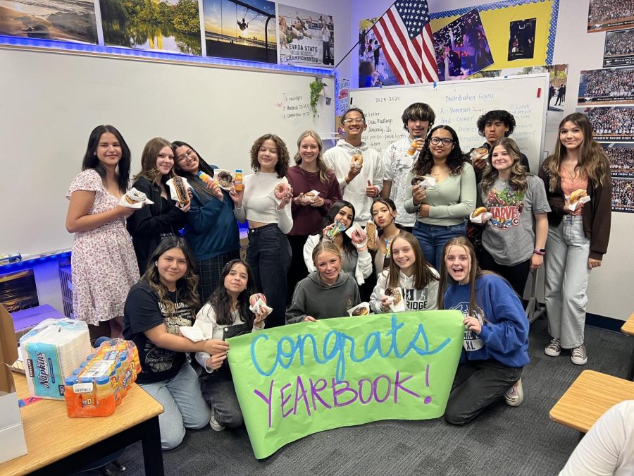 The yearbook staff enjoying their donuts after winning class of the month.