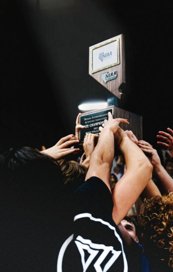 State Championship trophy being held up by team.