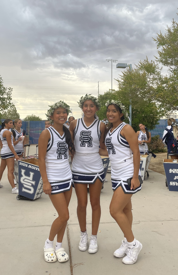 Paige Martinez (middle) and two other seniors on senior night