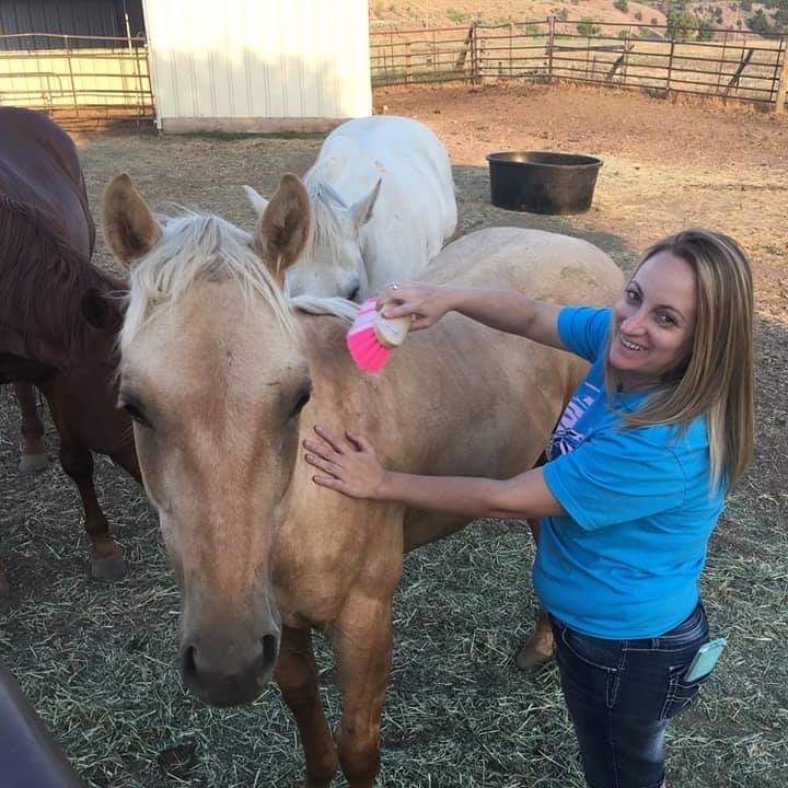 Mrs. Spencer taking care of some horses at a farm. (Courtesy of Tamara Spencer) 