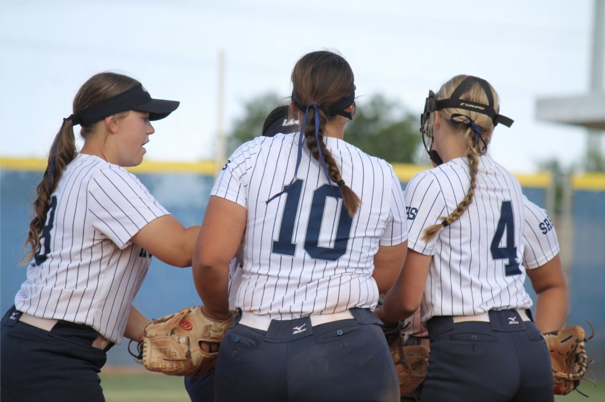 Softball players being good teammates on the field