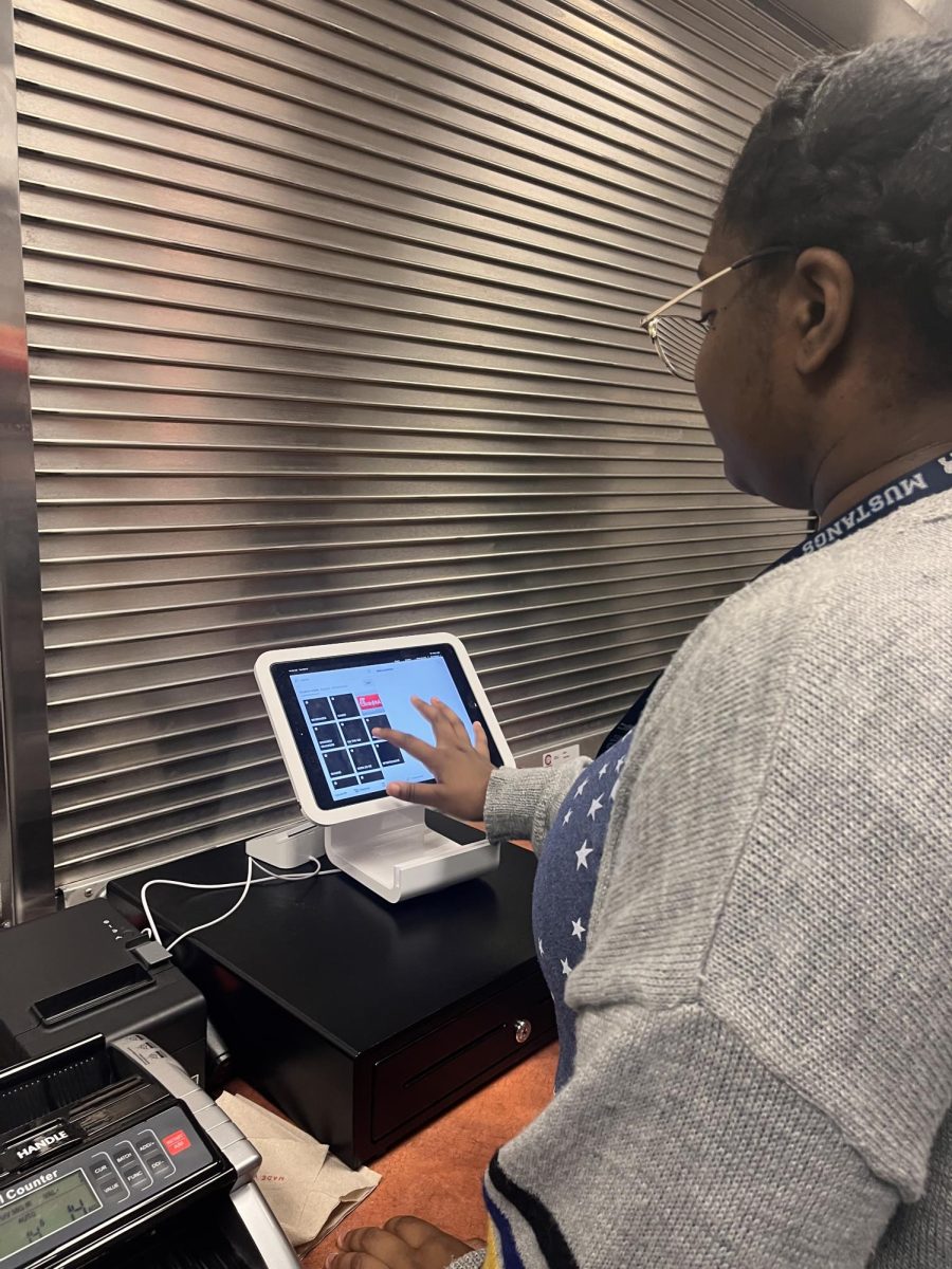 Student working the register at the student store.