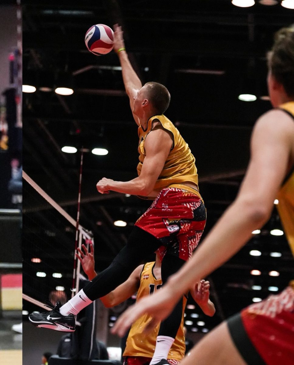 Owen Romzek running a tip ball as a middle during a game for his club team.