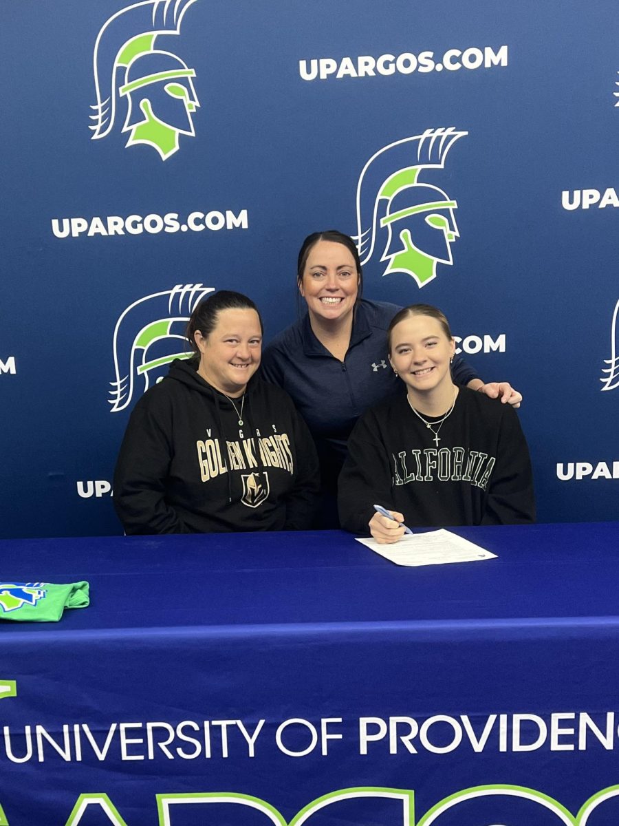 Alan with her teammate and coach on signing day.