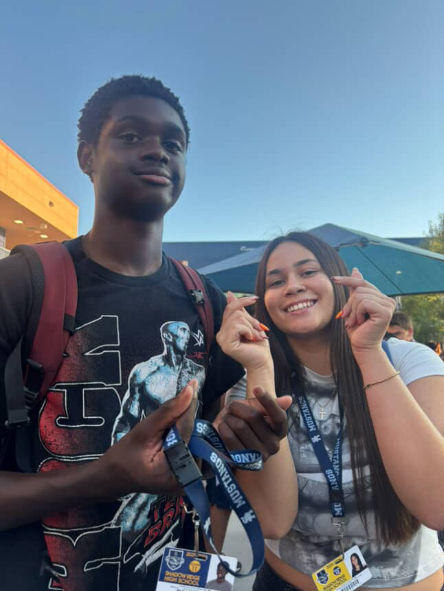 Brynne Alia taking a photo with one of her junior friends. 