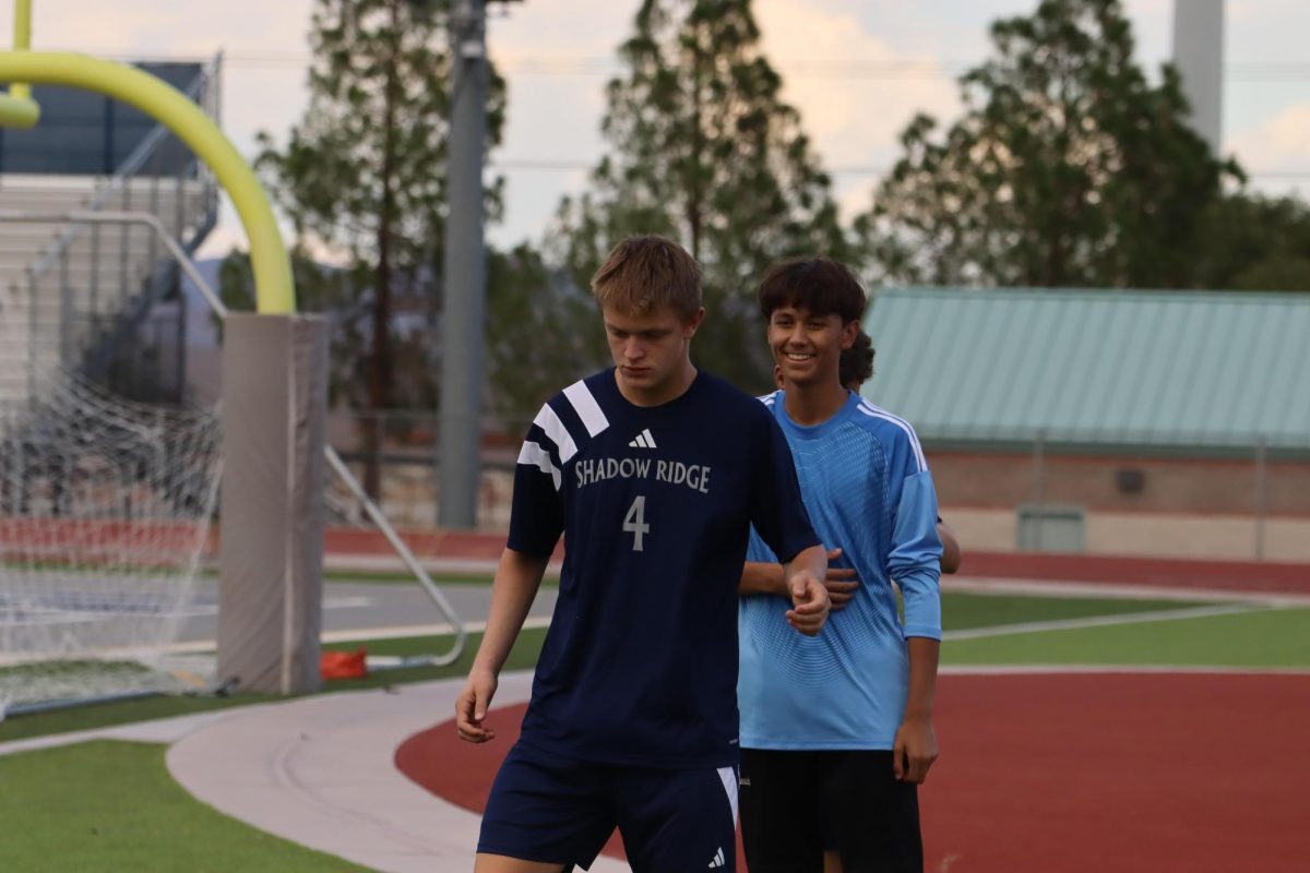 Gregory making a pass while his teammate waits in line. 