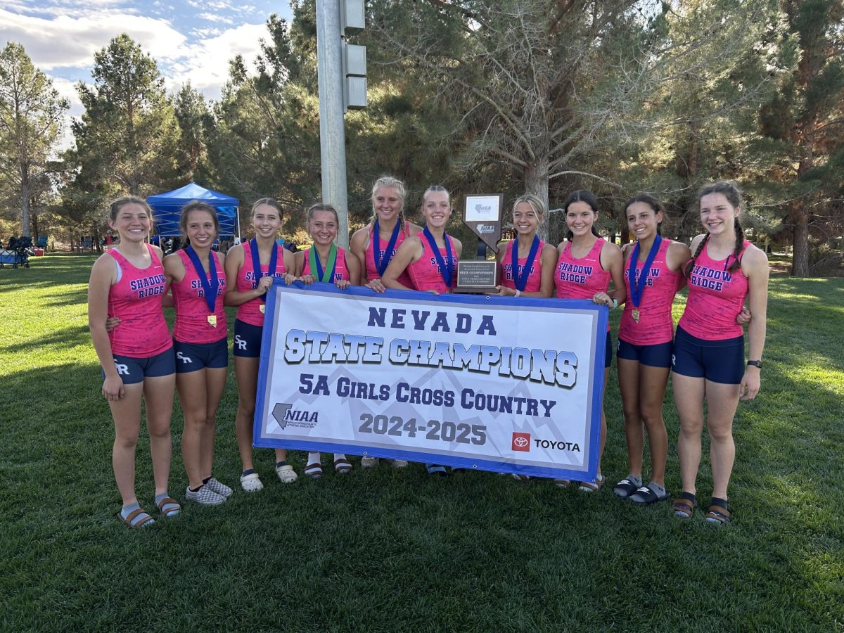 Ryen Hughes with her girls cross country team winning state in 2024-2025
