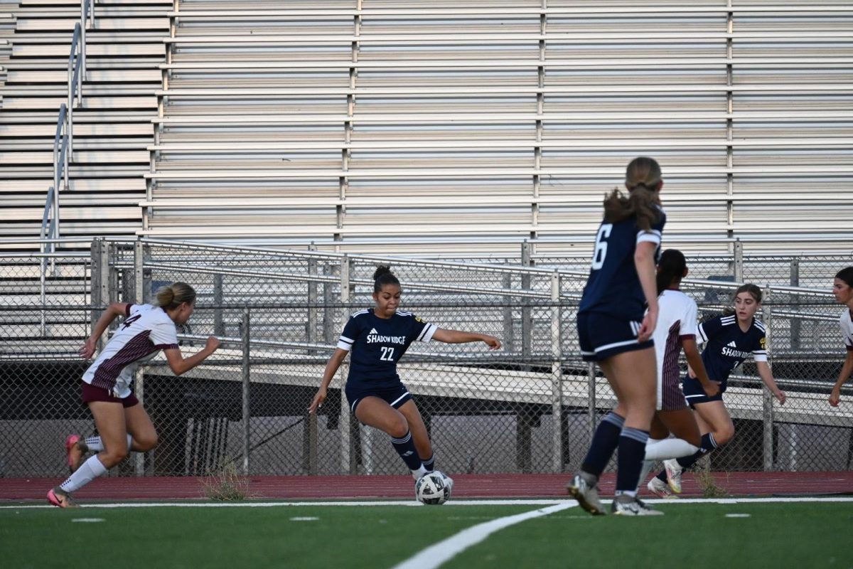 Ariella Garcia going in for a hard kick toward the opposing team's goal.