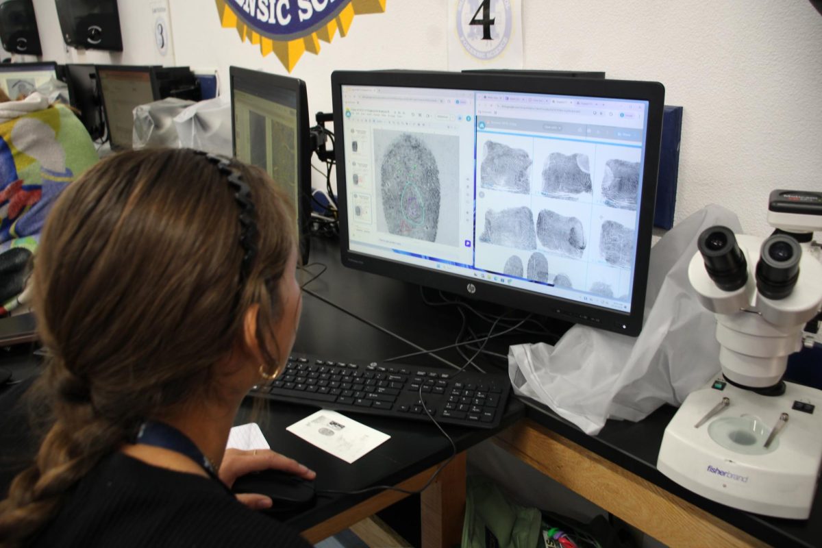 Savannah Abney examining fingerprints for a closer look