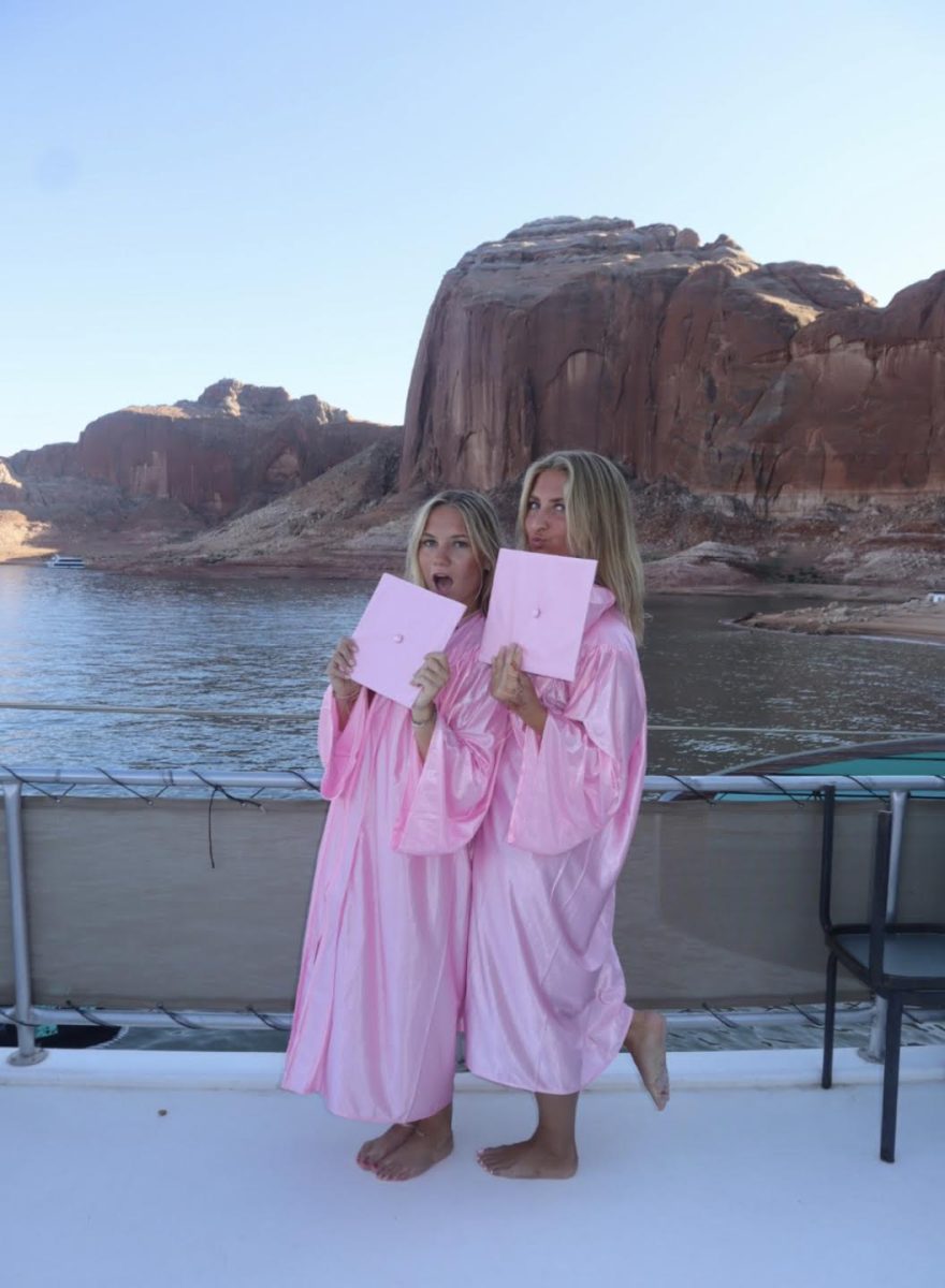 The twins, in pink grad gowns on their boat.