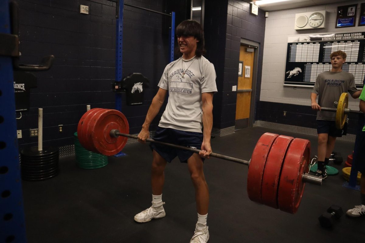 A student working out in weight room.