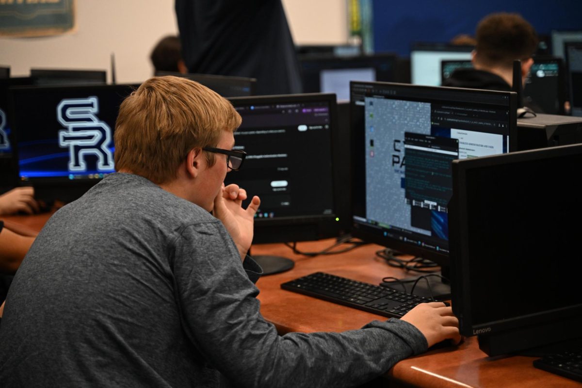 Student working on computer in Computer Science and Cybersecurity Club.