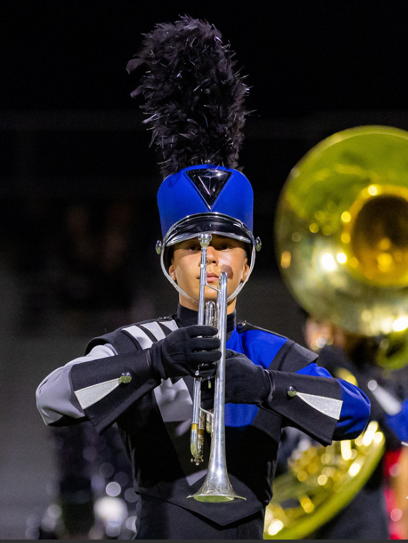 Corwin playing his instrument during a Shadow Ridge football game.