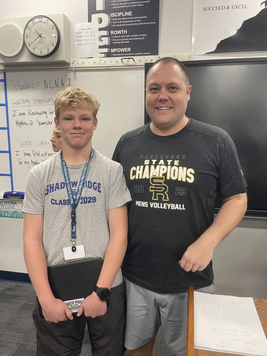 Mr. Wilson and "Teacher's pet,"  Tate Hughes take picture together at end of semester exam.