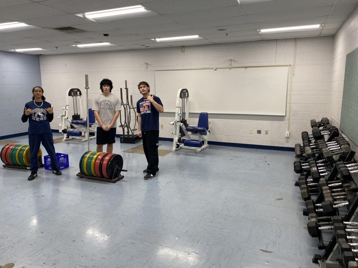 Students working out in the extra room in the weights classroom