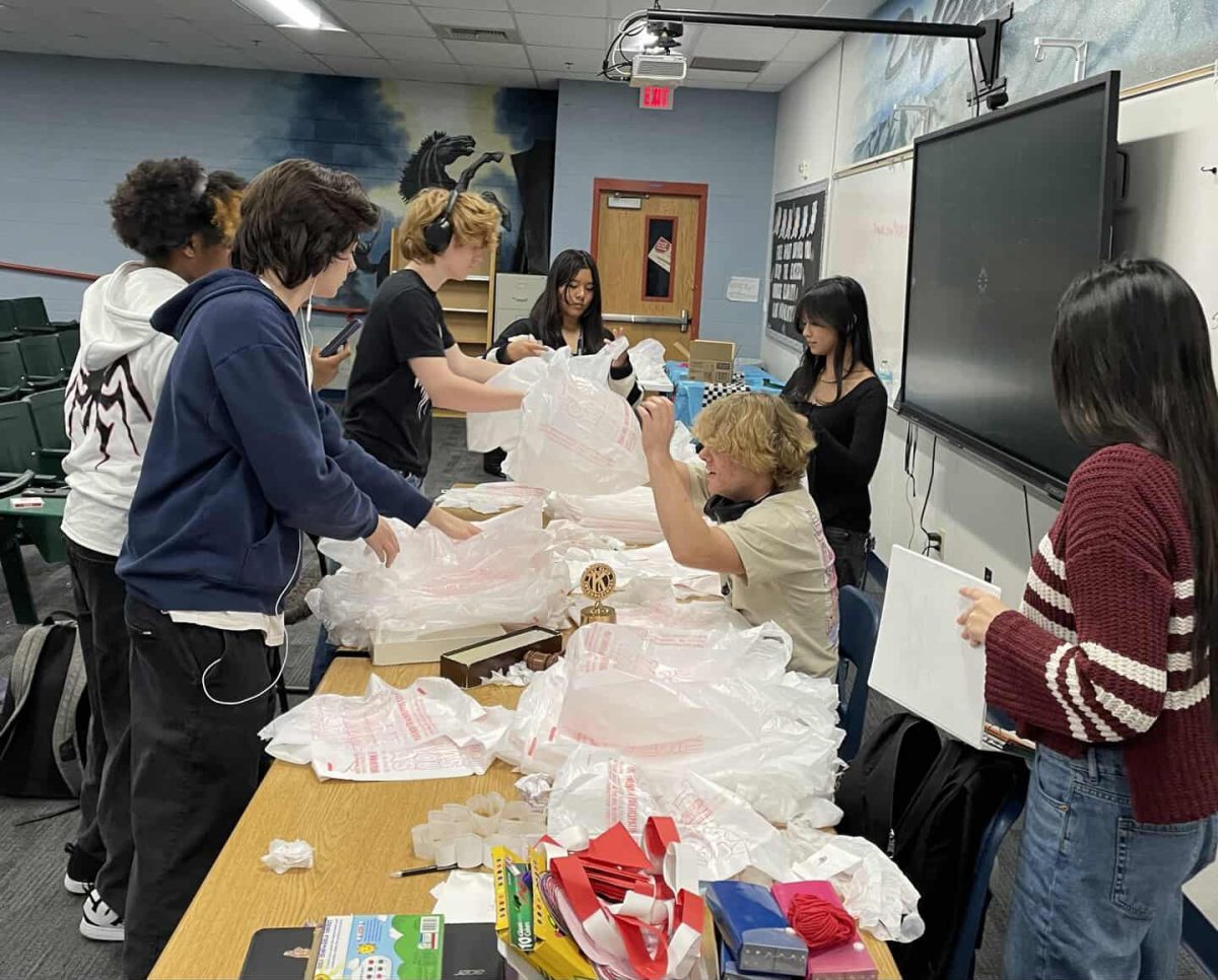 Key Club members with the plastics bags that are being used to create the mats.