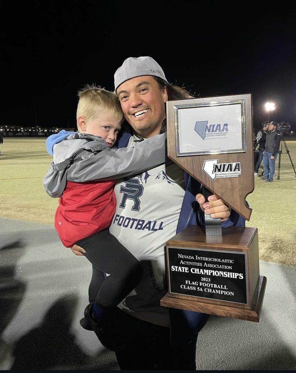 Drew Dubois with hia son after winning the Flag Football State Championship