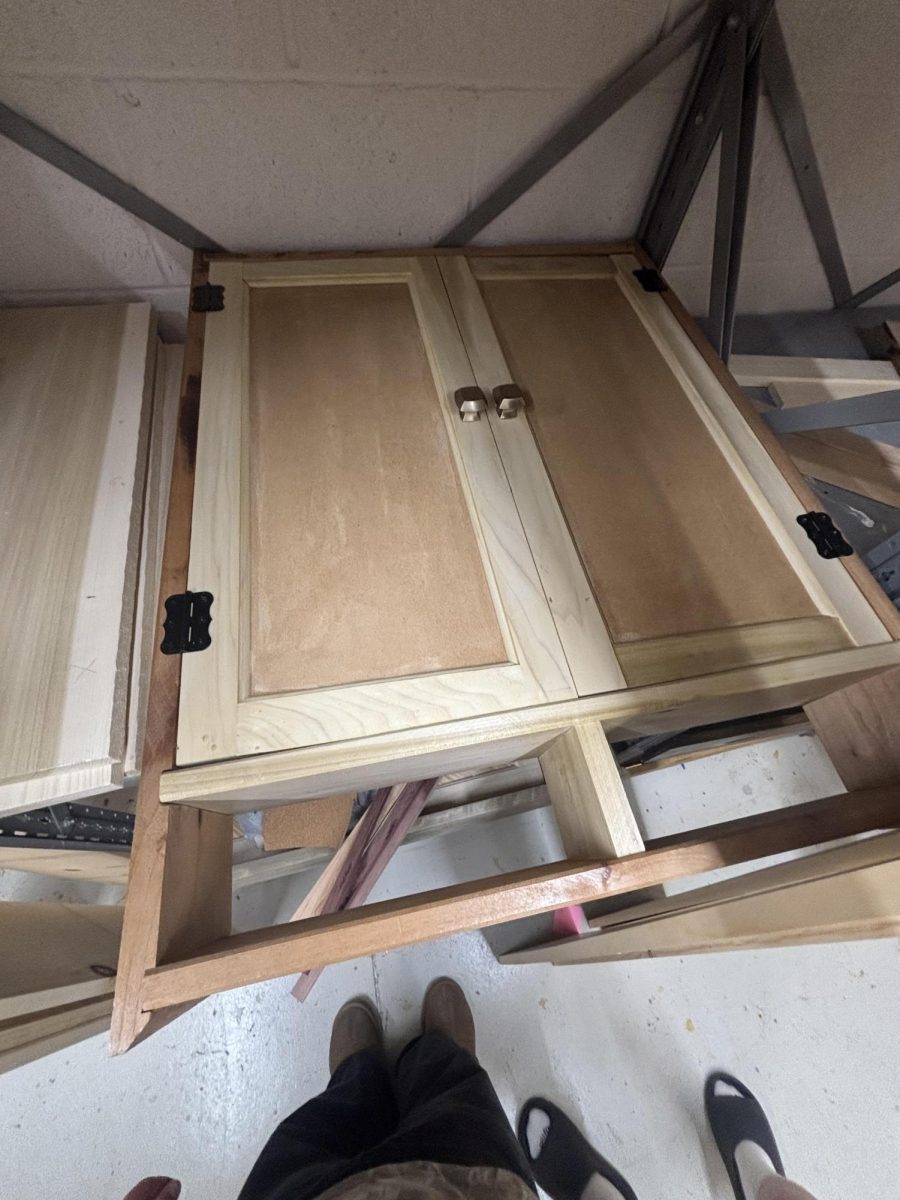 Nathan Giles working on dartboard cabinet.
