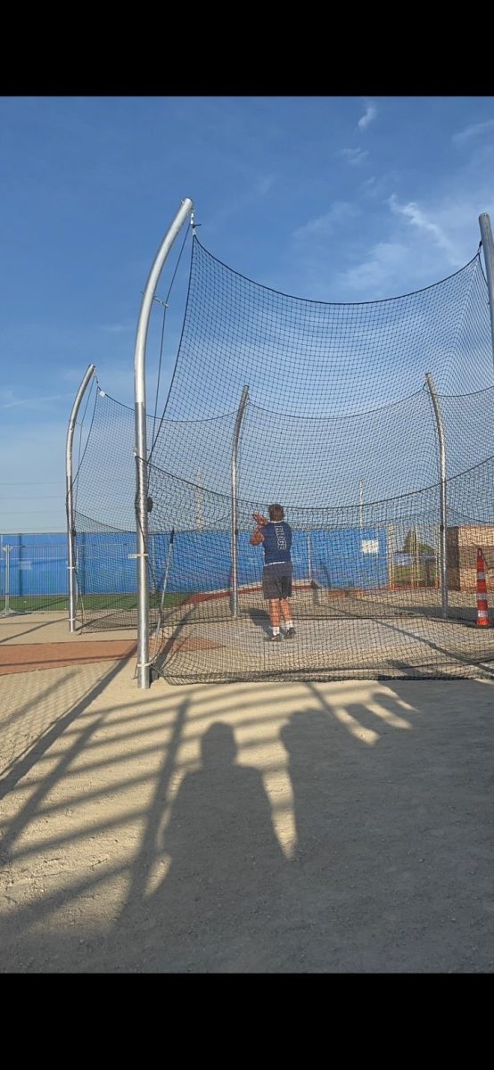 Max Trenholm doing shotput at a meet